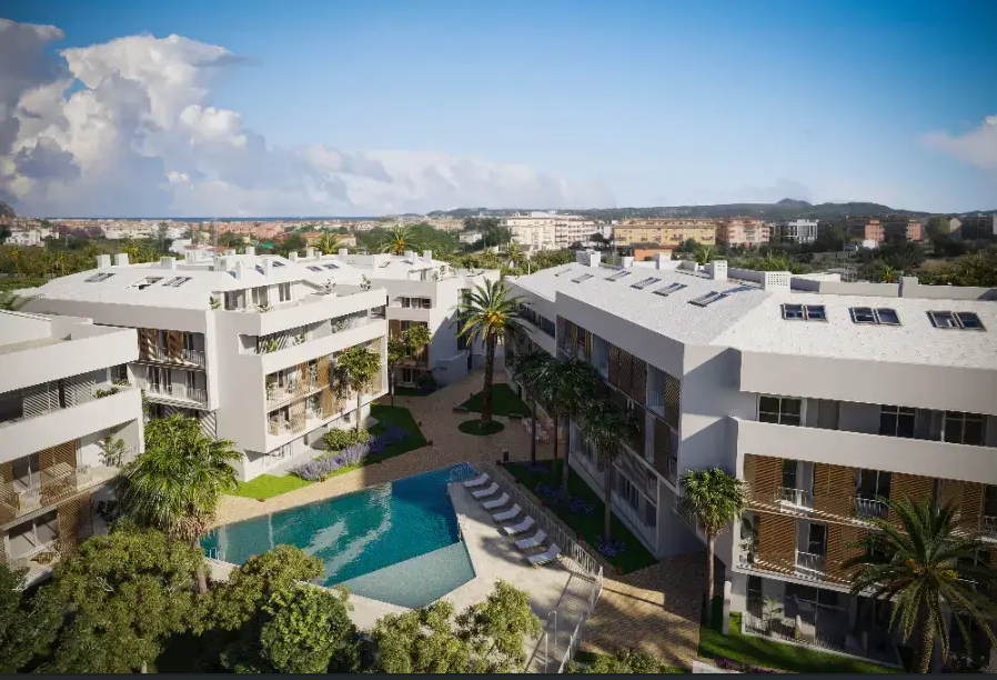 Elevated view of the modern residential complex featuring a geometric swimming pool, landscaped gardens with palm trees, and white contemporary architecture.