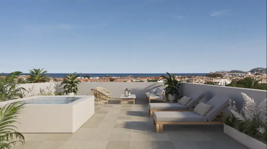 Spacious rooftop terrace featuring a private jacuzzi, sun loungers, and panoramic views of the Javea coastline and Mediterranean Sea.