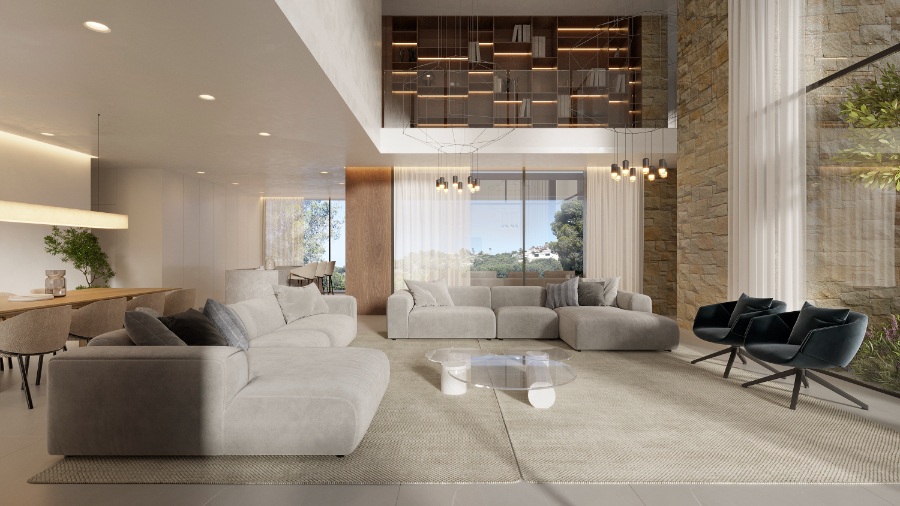 Spacious living area with double-height ceilings, featuring a stone-clad wall, mezzanine library with integrated lighting, and large glass doors opening to the landscape.