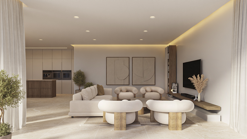 Open-plan living area featuring neutral-toned furniture, curved armchairs, and a floating wooden media shelf. Recessed lighting and stone flooring connect the lounge to the kitchen.