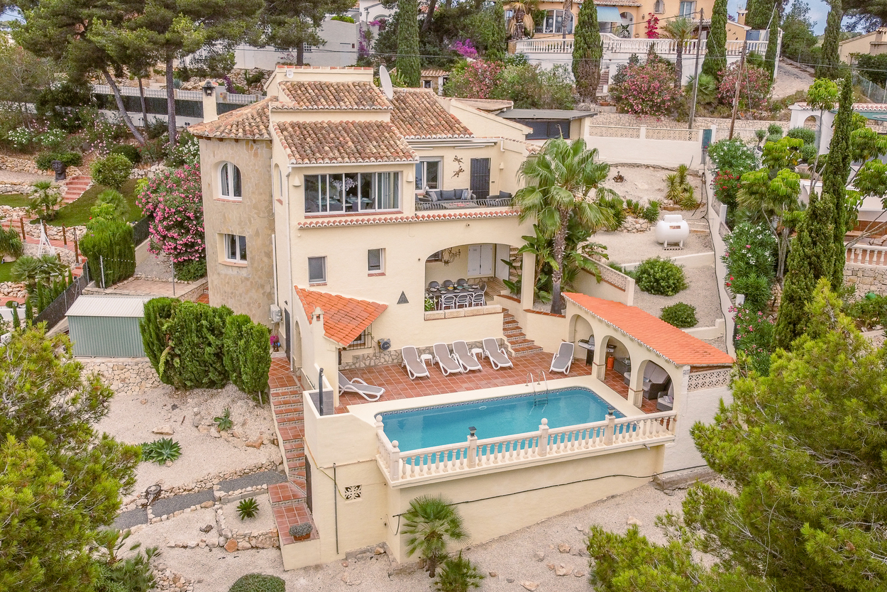 Elevated view of the south-facing villa featuring an 8x4m pool, terracotta sun terrace, and multiple covered nayas integrated into the tiered Mediterranean architecture.