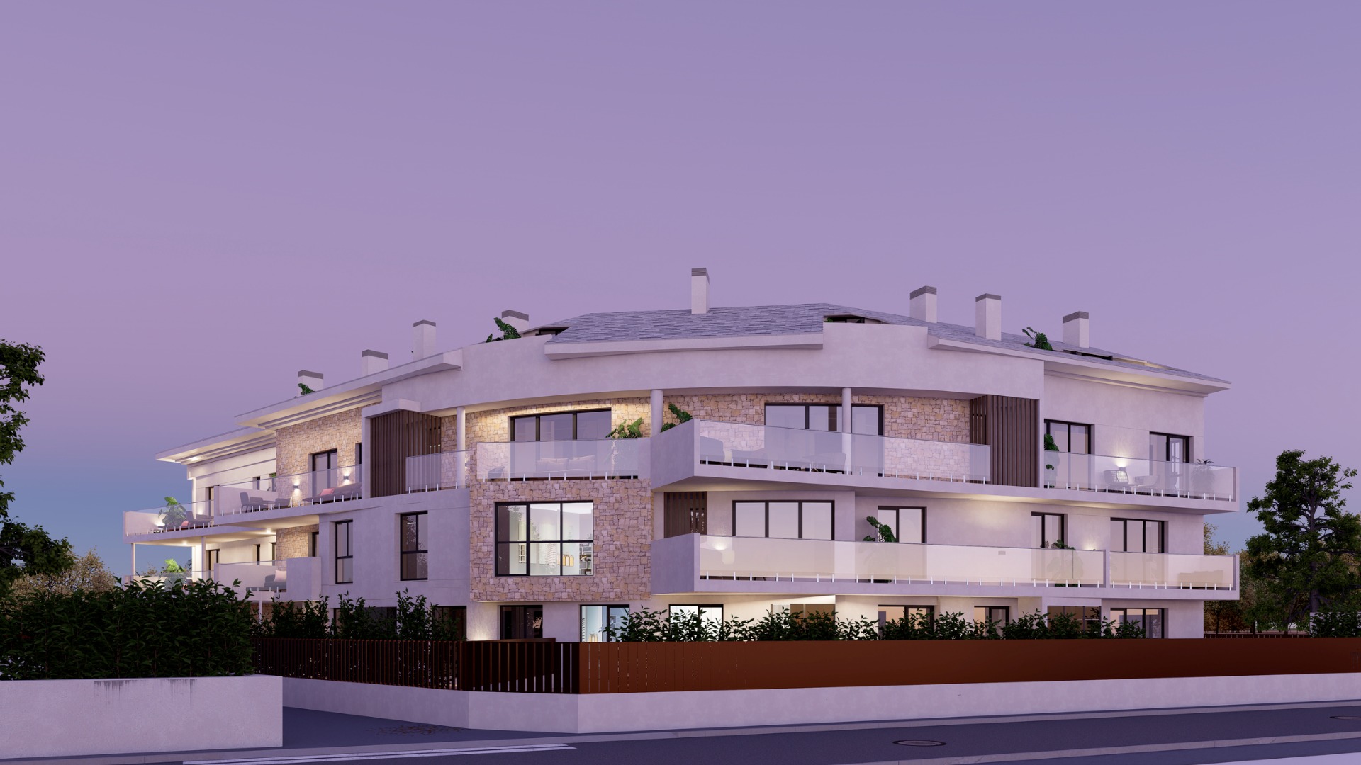 Exterior view of the three-storey residential building at twilight, featuring white facades, stone cladding, and wide terraces with glass railings and warm lighting.