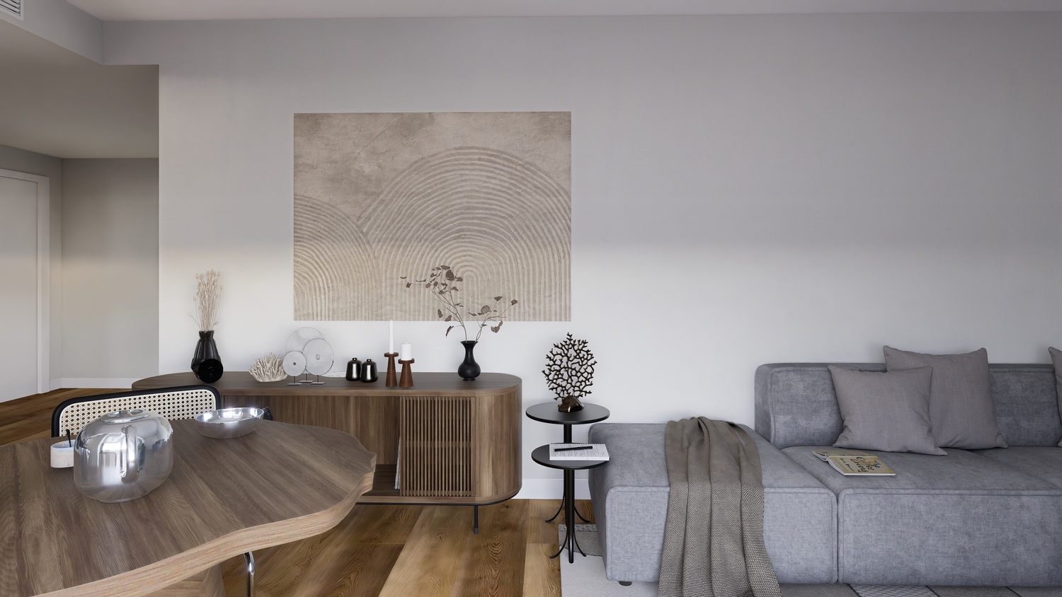 Modern living area featuring a grey modular sofa, a curved wooden sideboard with slatted details, and a large textured wall art piece above oak flooring.
