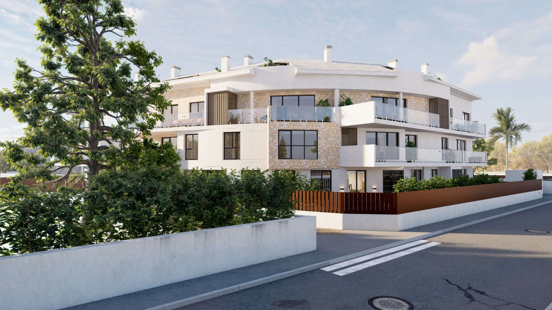 Modern three-story residential building with a curved facade, featuring natural stone cladding, glass-railed terraces, and integrated perimeter landscaping.