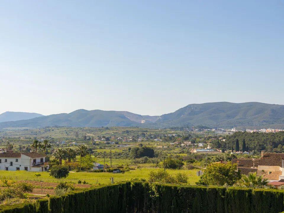 Clear panoramic views across the valley and mountains of the Costa Blanca, showcasing the rural landscape and Mediterranean greenery from the terrace.