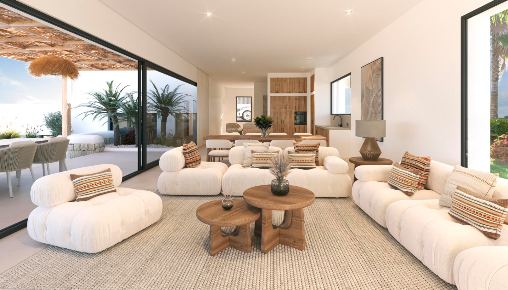 Open-plan living area featuring white modular sofas, wooden nesting tables, and floor-to-ceiling glass doors opening onto a shaded terrace with palm trees.