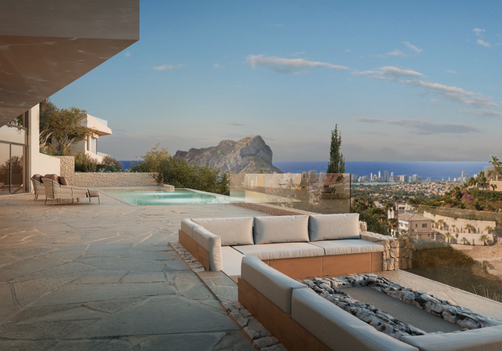 Terrace with pool & sea view. Outdoor seating with stone base and irregular paving slabs.